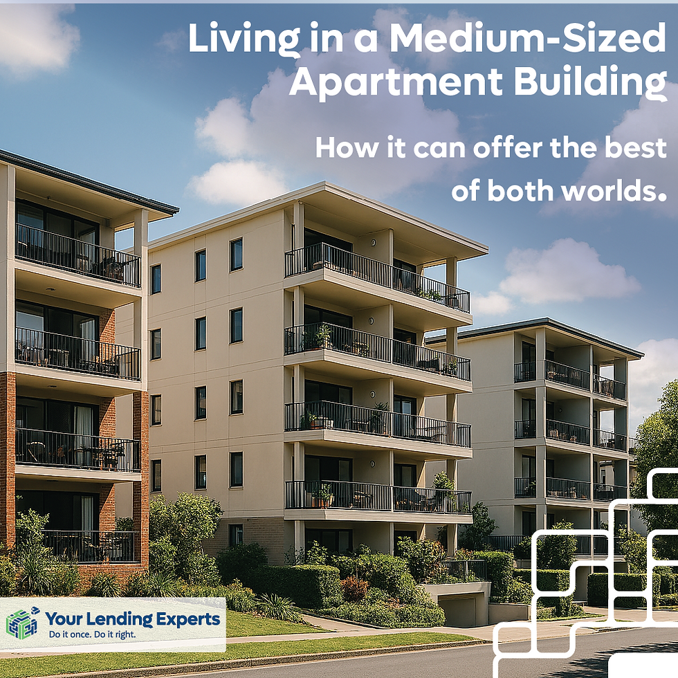 A modern medium‑sized apartment complex featuring several four‑level residential buildings with balconies, surrounded by landscaped gardens under a bright blue sky with scattered clouds. The image represents community living in mid‑sized apartment buildings, highlighting a clean, well‑maintained urban environment.